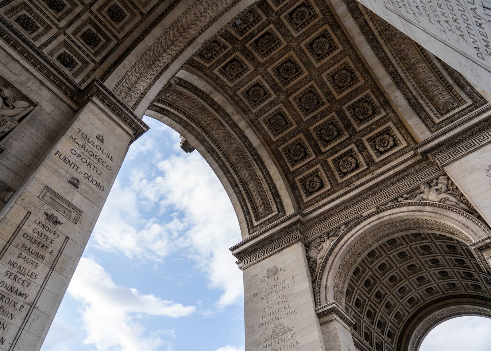 Looking up at the coffered stone ceiling of the Arc de Triomphe in Paris